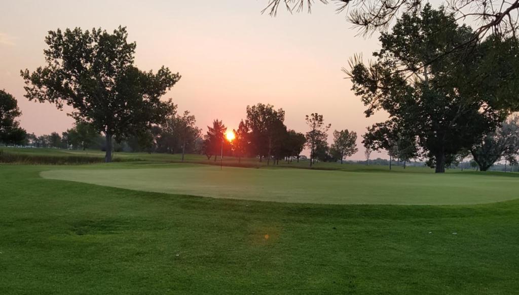 Sunset over golf course fairway